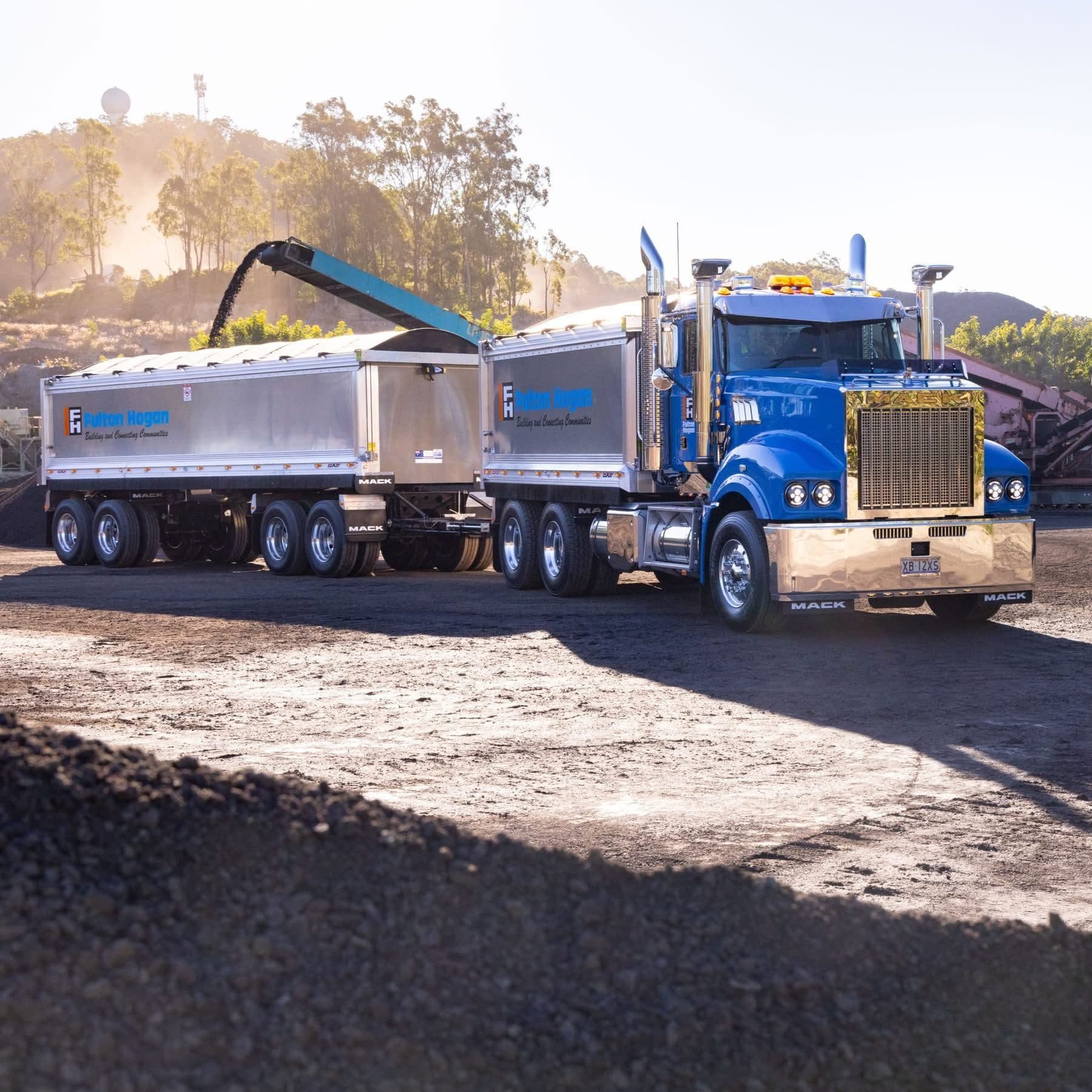 Blue Mack truck and dog being loaded