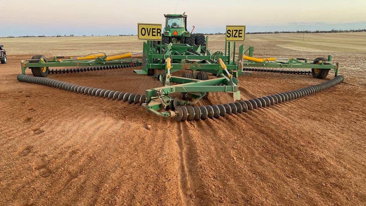 John Deere tractor towing an oversize tillage implement
